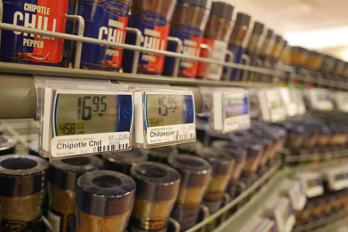 Jars of chili above electronic shelf tags showing prices